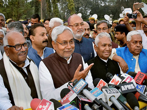 JD(U) senior leader Nitish Kumar with RJD leader Abdul Bari Siddiqui and Congress leader Ashok Chaudhary addressing media person outside Raj Bhawan in Patna. PTI Photo.