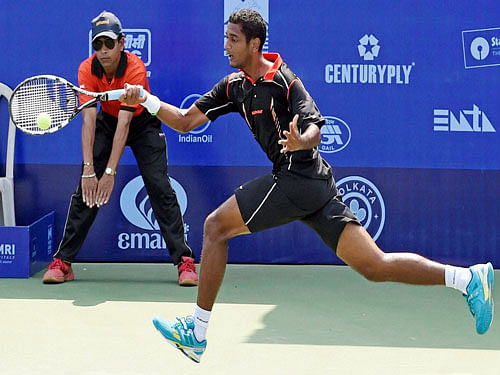 Indian tennis player Ramkumar Ramanathan in action against Somdev Devvarman during Kolkata Open 2015 at Salt Lake in Kolkata on Tuesday. PTI Photo