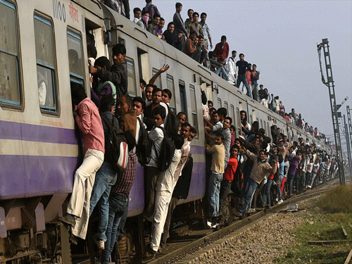 Commuters travel by a train at Loni in Ghaziabad on Thursday. Railway Minister Suresh Prabhu presented the Railway Budget 2015-16 in the Lok Sabha on Thursday. PTI Photo