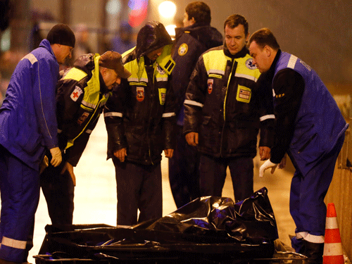 Medics stand near the body of Boris Nemtsov, who was shot dead, in central Moscow. Reuters Photo