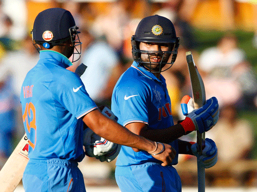 India's batsmen Virat Kohli and Rohit Sharma walk off the field during a scheduled break in play against the UAE during their Cricket World Cup match in Perth.Reuters Photo