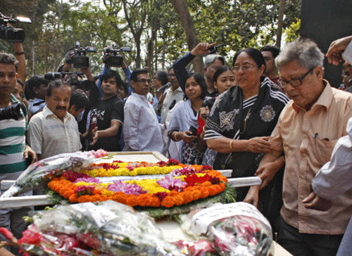 Father Ajay Roy, right, stands beside the coffin of Avijit Roy, a prominent Bangladeshi-American blogger in Dhaka, Bangladesh. AP photo