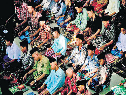 reinforcing values: Students praying at an Islamic boarding school in Medan, North Sumatra. Almost three-quarters of Indonesia's many pesantren teach secular subjects like science and history along with classical Islamic texts and vocational courses in agriculture. nyt