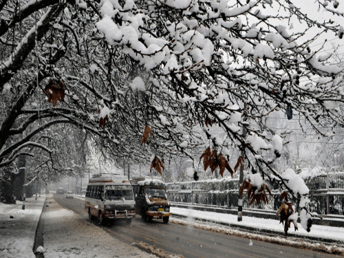 Vehicles ply after heavy snowfall in Srinagar.Kashmir Valley was today cut off from rest of the country following the season's heaviest snowfall at most places including the summer capital Srinagar. PTI photo