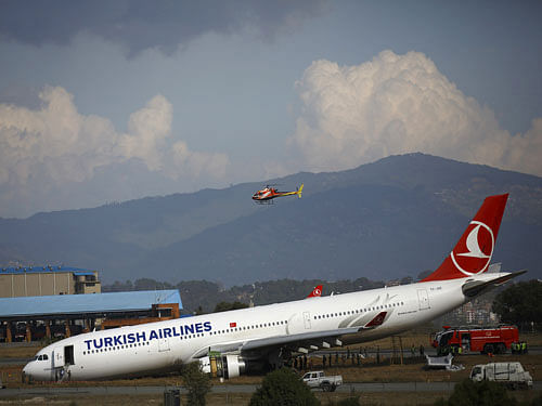 A Turkish Airlines plane lies on a field after it overshot the runway at Tribhuvan International Airport in Kathmandu. Reuters image