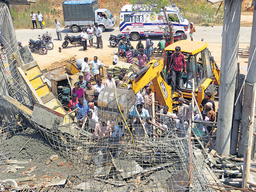 crash: An earthmover is clearing the debris of an under-construction building that collapsed at Bejarallikatte village in Ramanagar taluk on Thursday. DH photo