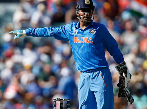 Indian captain M S Dhoni gestures to his team while fielding during their Cricket World Cup Pool B match against the West Indies in Perth, Australia, Friday, March 6, 2015. AP