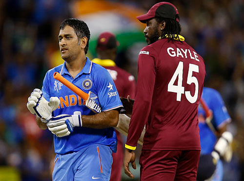 Indian captain M S Dhoni, left, is congratulated by West Indies Chris Gayle after there four wicket win in their Cricket World Cup Pool B match in Perth, Australia, Friday, March 6, 2015. AP Photo
