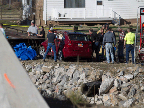 In this March 7, 2015 photo, officials respond to a report of car in the Spanish Fork River near the Main Street and the Arrowhead Trail Road junction in Spanish Fork, Utah. An 18-month-old girl survived a car crash in a frigid Utah river after being strapped in a car seat upside-down for some 14 hours before being found by a fisherman, but her 25-year-old mother, Lynn Groesbeck, of Springville, was found dead in the car, police said Sunday. AP Photo