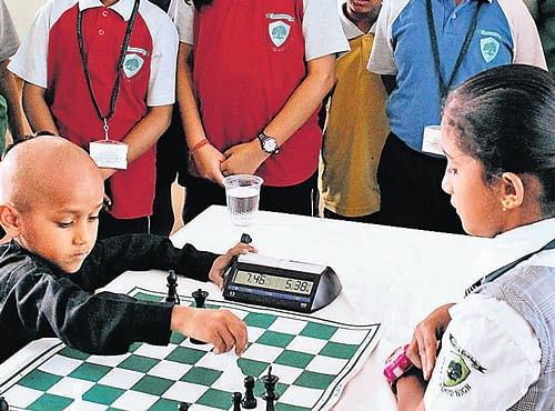 CHILD PRODIGY Kautilya Pandit (in black) engrossed in a gameof chess.