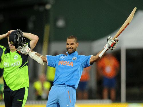 India's Shikhar Dhawan celebrates after scoring a century while batting against Ireland during their Cricket World Cup Pool B match in Hamilton, New Zealand, Tuesday, March 10, 2015. AP Photo