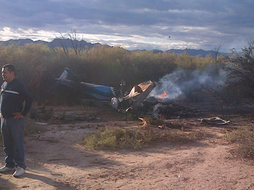 A man stands near one of two helicopters that crashed near Villa Castelli in the La Rioja province of Argentina, Monday, March 9, 2015. Two helicopters with passengers who were filming a documentary crashed Monday in the remote area of northwest Argentina, killing all 10 people on board both aircrafts, authorities said. AP Photo