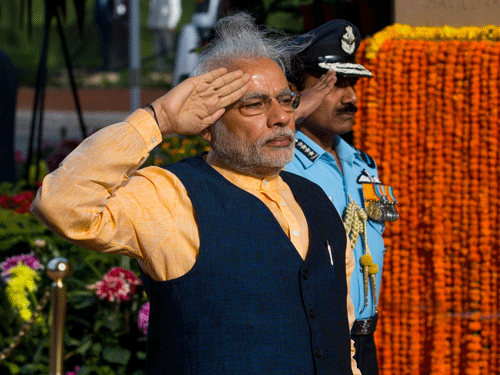 Indian Prime Minister Narendra Modi salutes in front of a World War I memorial at India Gate, flanked by Naval chief Admiral R.K. Dhowan, left, and Air Chief Marshal Arup Raha in New Delhi, India, Tuesday, March 10, 2015. The Indian Army is organizing a series of events that began Monday to commemorate the valor and sacrifice of Indian soldiers who fought in the First World War. AP Photo