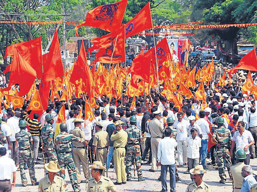 Activists of Vishwa Hindu Parishat during the Samajothsava in Hassan, on Tuesday. Police commissioner M A Saleem is seen addressing police officials ahead of Hindu Samajothsava, in Mysuru, on Tuesday. dh photo