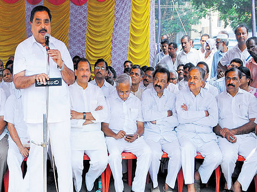 District-in-Charge Minister Ramanath Rai speaks at a protest against the Central government's move to amend the Land Acquisition Act, in front of Deputy Commissioner's office in Mangaluru on Wednesday. MLA J R Lobo, MLC Ivan D'Souza and others look on. DH Photo