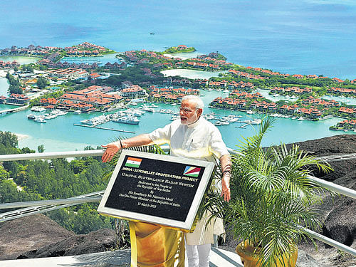building a base: Prime Minister Narendra Modi unveils a plaque during the dedication of the India-Seychelles cooperation project-'Coastal Surveillance Radar System'-in Mahe on Wednesday. PTI