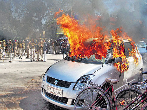 Angry advocates set ablaze vehicles after a clash in the court campus in Allahabad on Wednesday. PTI