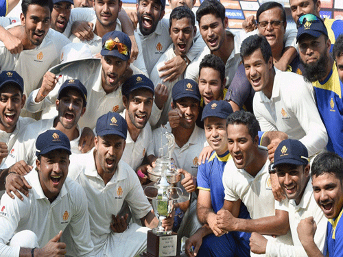 A jubilant Karnataka team with the Ranji Trophy at the Wankhede Stadium in Mumbai on Thursday. They defeated Tamil Nadu in the final. DH Photo/ Kishor Kumar Bolar