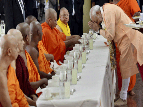 Prime Minister Narendra Modi greets Buddhist monks during a visit at Mahabodhi Society in Colombo on friday. Modi today paid a visit to Sri Lanka's ancient capital Anuradhapura and offered prayers at the sacred Mahabodhi tree in a move aimed at projecting India's Buddhist links in the region. PTI photo