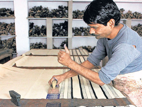 Textile glories A bagru craftsman prints patterns on cloth.