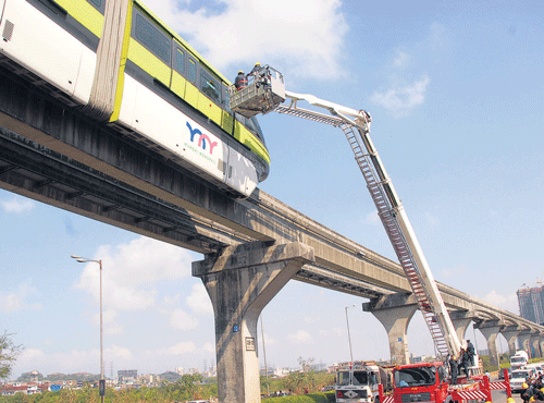 RESCUE MISSION: Passengers being rescued fromthe strandedmonorail on Sunday. DH PHOTO