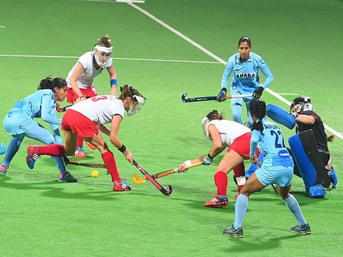 Indian players vie for ball against Poland during the FIH hockey world league final (Women) match, in New Delhi on Sunday. PTI Photo.