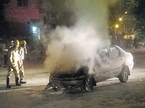 A car went up in flames close to a petrol bunk near Lal BaghWest Gate on Sunday evening. DH PHOTO