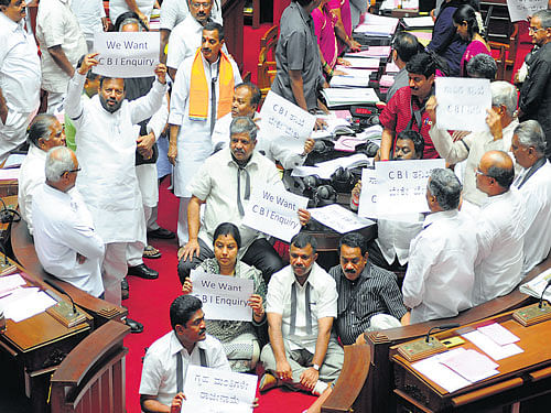 Oppositionmembers stage a dharnademanding a CBI probe into the unnatural death of IAS officerDK Ravi, in the Legislative Council onWednesday. DH PHOTO