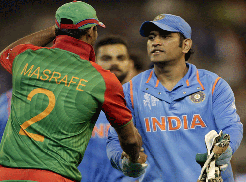 Bangladesh captain Mashrafe Mortaza shakes hands with India's captain MS Dhoni after India's 109-run Cricket World Cup quarter final win over Bangladesh in Melbourne. Reuters photo