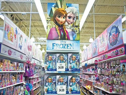 Battle of toys: Disney "Frozen" toys on display at a Toys R Us store. As moviegoers salivate over the batch of superhero movies to be released this year, experts question whether the toy industry can expand enough to accommodate what could be a glut of new products.  nyt