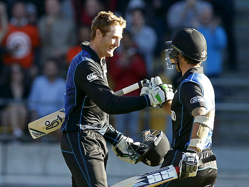 New Zealand's Martin Guptill (L) celebrates scoring a double century with Luke Ronchi against the West Indies during their Cricket World Cup match in Wellington, March 21, 2015. REUTERS