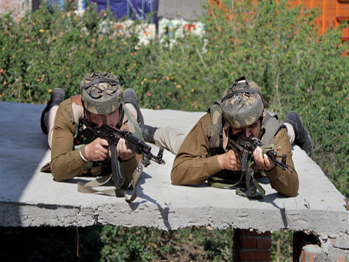 Security personnel take up positions during an encounter with militants at Mehasar army camp in Samba district of Jammu and Kashmir. The I&B Ministry has issued an advisory to all TV channels not to broadcast live anti- terrorist operations to avoid any adverse impact on rescue exercise. PTI photo