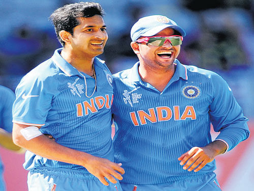 team spirit: Mohit Sharma (left) and Suresh Raina have risen to the occasion in splendid fashion many times this World Cup, playing key roles in India's succcess. AP