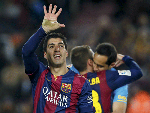Barcelona's Suarez waves to supporters at the end of their Spanish first division 'Clasico' soccer match against Real Madrid at Camp Nou stadium in Barcelona. Reuters Photo