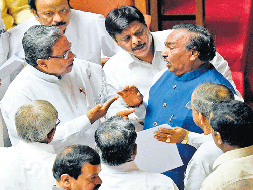 Chief Minister Siddaramaiah talks to Leader of the Opposition K S Eshwarappa at the Legislative Council on Monday. Ministers R Roshan Baig, H C Mahadevappa and other members are with them. DH PHOTO