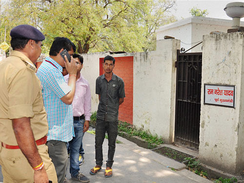 Police personnel inspect outside the residence of Madhya Pradesh Governor Ram Naresh Yadav after his son Shailesh Yadav committed suicide, in Lucknow on Wednesday. PTI Photo