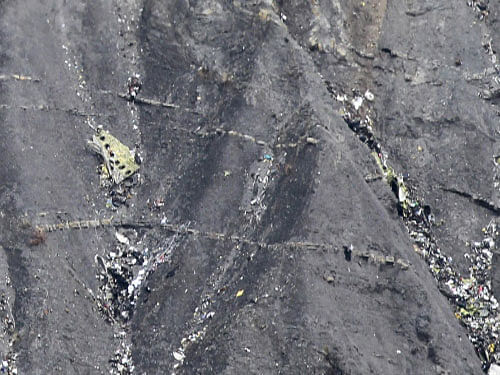 Debris from wreckage is seen in this aerial view of the crash site of an Airbus A320, near Seyne-les-Alpes. Investigators have retrieved cockpit voice recordings from one of the 'black boxes' of the German jet that crashed in the Alps, killing everyone onboard, and the New York Times said the audio showed one of the pilots left the cockpit and could not get back in before the plane went down. Reuters photo
