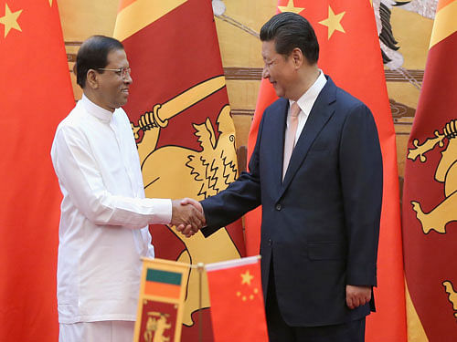 Sri Lankan President Maithripala Sirisena, left, shakes hands with Chinese President Xi Jinping during a signing ceremony in the Great Hall of the People Thursday, March 26, 2015 in Beijing, China. Sri Lanka's new president held talks with Xi amid a push to recalibrate his predecessor's strongly pro-China policies and a review of major Chinese projects in the island nation. AP Photo.