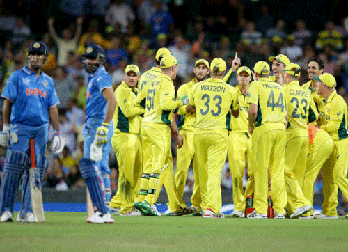 Australian players watch a video replay of the run out of India's Ravindra Jadeja, second left, during their Cricket World Cup semifinal in Sydney. AP photo