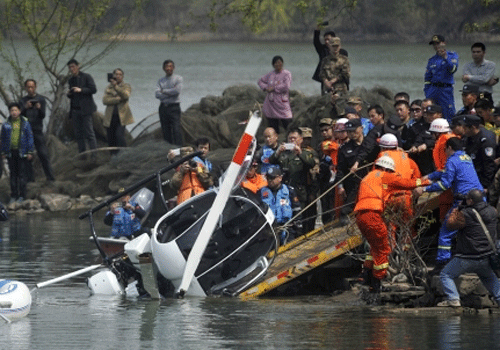 Rescuers pull the wreckage of a small helicopter out of a lake in Hefei. Reuters photo