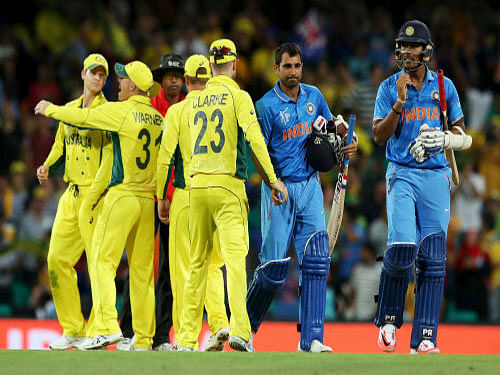 India's batsmen Umesh Yadav (R) and Mohammed Shami walk off the field after Australia won their Cricket World Cup semi-final match in Sydney, March 26, 2015. Reuters Photo.