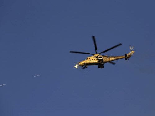 An Iraqi military helicopter attacks Islamic State group positions during clashes in Tikrit. Iraqi troops started the final phase of an offensive to recapture Saddam Hussein's hometown of Tikrit today, a military official said, just hours after the United States launched airstrikes on the Islamic State-held city. AP photo