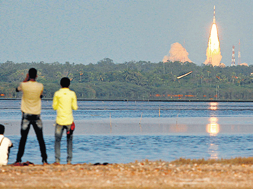 People watch the PSLV-C27 taking off with the fourth navigational satellite in Sriharikota, on Saturday. AP