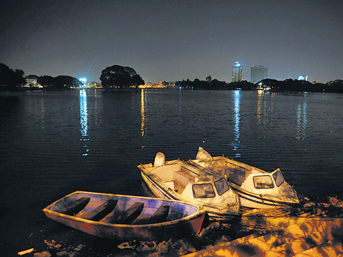 DIMMINGOUT:Aviewof the Ulsoor lake and the surrounding high-rises during the 'Earth Hour' on Saturday night. DH PHOTO/SATISH BADIGER