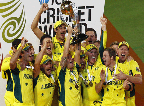 Australia's captain Clarke holds aloft the Cricket World Cup trophy as he celebrates with team mates after they defeated New Zealand in the final match at the MCG. Reuters