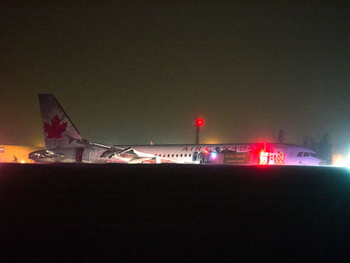 Air Canada flight 624 rests off the runway after landing at Stanfield International Airport in Halifax, Canada on Sunday, March. 29, 2015. Air Canada says at least 22 people were taken to hospital. The flight had 132 passengers and five crew members. AP Photo