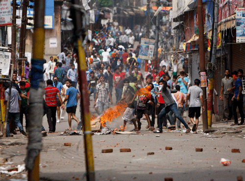 Indian Hindu protesters throw stones at policemen during a protest after rival communities clashed in Kishtwar, in Jammu, India, Saturday, Aug. 10, 2013. AP file photo