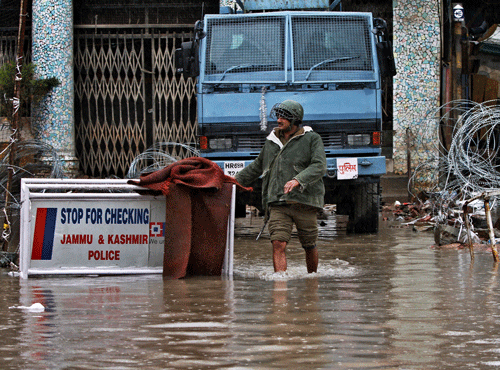 An Indian paramilitary soldier walks through a flooded street following heavy rains in Srinagar, Indian controlled Kashmir, Sunday, March 29, 2015. AP file photo