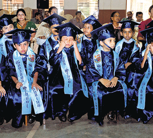 Little students of Gonzaga school await for their turn to receive 'degrees' at the kindergarten's graduation ceremony on the school premises in Mangaluru. DH PHOTO