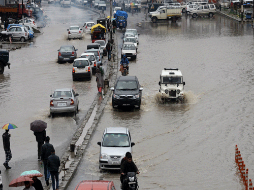 Vehicles move along a flooded road in Srinagar after heavy rainfall on March 29, 2015. Parts of Srinagar were waterlogged following sustained rains since March 28, with forecasters warning the wet weather would likely continue. Floods and landslides triggered by heavy monsoon rains devastated parts of Indian-administered Kashmir in September 2014. AFP PHOTO